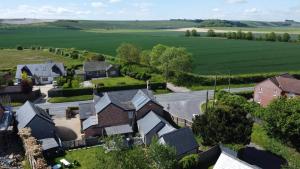 an aerial view of a village with houses and a road at The Old Pub Wiltshire A Unique Luxury Cellar Retreat with Private Sauna Gym and Movie Room in Patney