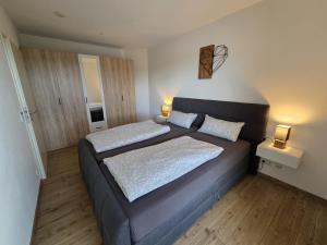 a bedroom with two beds and two lamps in it at RoSa Haus in Steingaden