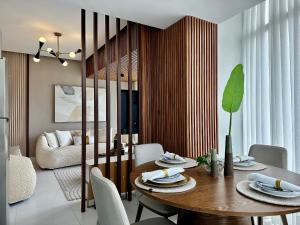 a dining room with a wooden table and chairs at Shalom Suites by Yellowkey in Santo Domingo