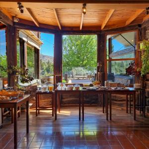 a dining room with a table with food on it at Suites de la Colina in La Cumbrecita