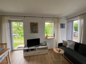 a living room with a couch and a tv at Wohnung am Rande der Nordheide in Welle