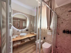 a bathroom with a sink and a mirror at Suite spa civico 4 in Follonica +19 photos