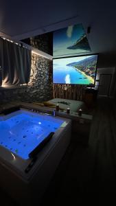 a large tub in a room with a tv at Suite spa civico 4 in Follonica