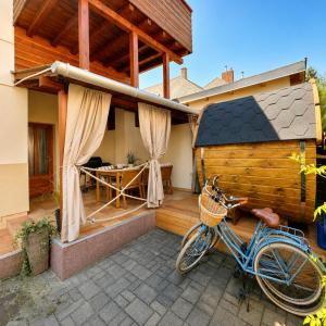 a bike parked in front of a house at Dora Holiday House & Apartments -Sauna & Relax by the Lake in Keszthely