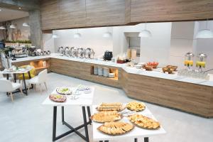 a kitchen with two tables with food on it at Hotel Casino Internacional in Cúcuta