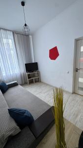 a bedroom with a bed and a tv in it at Central Square Apartment in Ternopil +7 photos