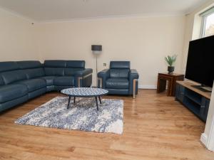 a living room with a couch and a coffee table at 31 Llys Ogwen in Prestatyn