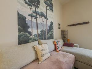 a living room with a couch and a painting on the wall at L'échappée in Collobrières