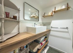 a bathroom with a sink and a mirror at L'échappée in Collobrières +9 photos