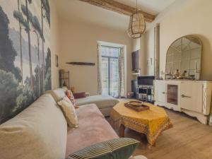 a living room with a couch and a table at L'échappée in Collobrières