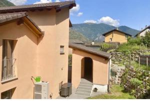 a view of a house with mountains in the background at Casa Annalisa in Intragna