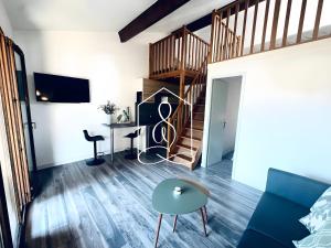 a living room with a staircase and a blue couch at La Petite Provence in Tourrettes
