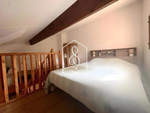 a bedroom with a bed with a peace sign on it at La Petite Provence in Tourrettes