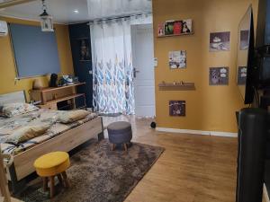 a bedroom with a bed and a table and a chair at Loc 'FCathy in Saint-Benoît