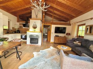 a living room with a couch and a fireplace at CHALET BELLE KITZ by Belle Stay in Kitzbühel