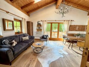 a living room with a couch and a table at CHALET BELLE KITZ by Belle Stay in Kitzbühel