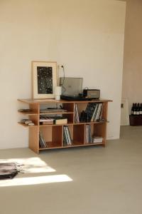 a book shelf with a computer on top of it at Dadi House Martvili in Martvili