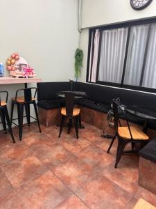 a room with tables and chairs and a table and a counter at Hostal Matta in Antofagasta