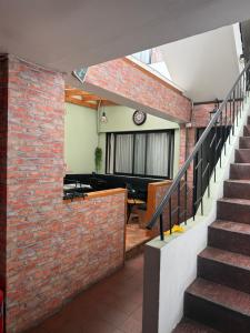 a brick house with a staircase and a living room at Hostal Matta in Antofagasta