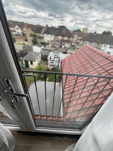 a balcony with a view of a house at Deluxe family room in Chessington