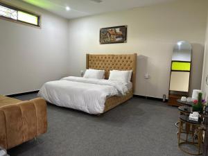 a bedroom with a large bed with white sheets and pillows at Hotel comfort hill in Abbottabad