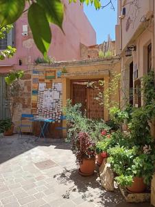 a courtyard with potted plants in front of a building at Odyssey House in Chania
