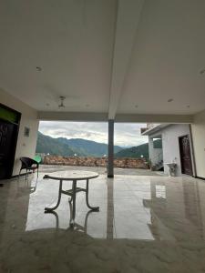 a table in the middle of a room with a view at Hotel comfort hill in Abbottabad