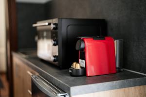 a red appliance sitting on top of a counter at Meraki luxury bungalows in Rakhónion