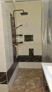 a bathroom with a shower and a sink at Amerix resorts and adventures in Diani Beach +8 photos
