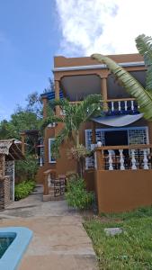 a house with a swimming pool in front of it at Amerix resorts and adventures in Diani Beach