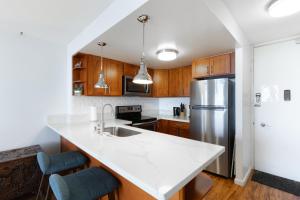 a kitchen with a white counter top and a refrigerator at Ilikai Marina 1394 in Honolulu