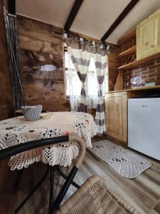 a dining room with a table and a refrigerator at Konaciste Mali Izvor in Boljevac
