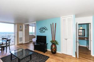 a living room with blue walls and a table at Ilikai Marina 984 in Honolulu