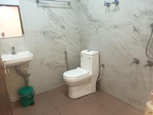 a bathroom with a toilet and a sink at S P Nettoor in Cochin