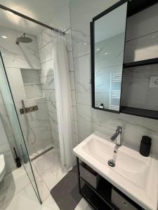 a white bathroom with a sink and a shower at Sea View Luxury Apartment Beachfront 3BR in Agia Triada +18 photos