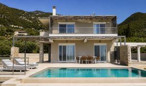 a house with a swimming pool in front of a house at Villa Palomar in Kyparissia