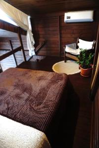 a bedroom with a bed and a chair in a room at Hop Village in Praia do Rosa +23 photos