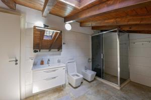 a bathroom with a toilet and a sink and a shower at Villa Madera in Shirokë +39 photos