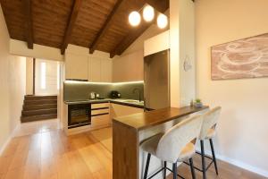 a kitchen with a counter and two chairs in it at Villa Madera in Shirokë