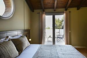 a bedroom with a bed and a sliding glass door at Villa Madera in Shirokë