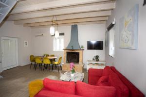 a living room with a red couch and a fireplace at Central Hotel in Parga