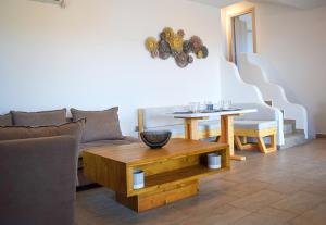 a living room with a couch and a table at Delta Villa's Kythnos II in Kithnos