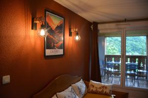 a bedroom with two lights on the wall and a window at Cauterets Mountain Nest in Cauterets