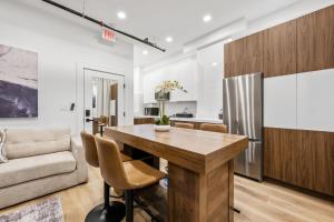 a kitchen and dining room with a table and a couch at SympleLive Hotel in Boston