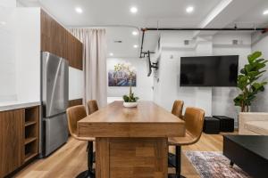 a dining room with a table and a tv at SympleLive Hotel in Boston