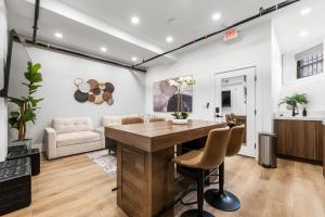a dining room and living room with a wooden table and chairs at SympleLive Hotel in Boston