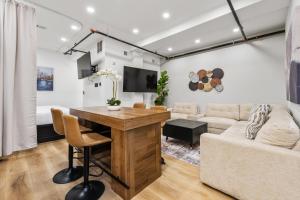 a living room with a table and a couch at SympleLive Hotel in Boston +100 photos