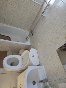 a bathroom with a toilet and a sink at Indie little house in Limassol +12 photos