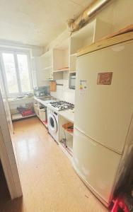 a kitchen with a stove and a refrigerator at Private Room Pré-Saint-Gervais in Le Pré-Saint-Gervais