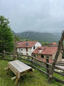 a wooden picnic table in front of a fence at Benaki 92B in Ladines +6 photos
